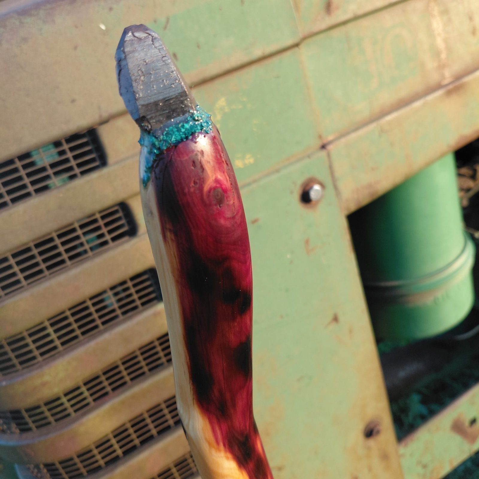 An eastern red cedar wand tipped with a clear quartz point bedded in crushed turquoise